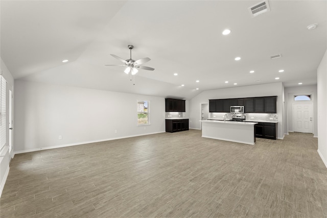 1825 Osage Trl, Mesquite, TX 75149 - unfurnished living room with lofted ceiling, a sink, a ceiling fan, recessed lighting, and baseboards