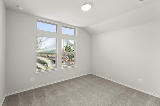 1825 Osage Trl, Mesquite, TX 75149 - empty room featuring carpet, plenty of natural light, baseboards, lofted ceiling, and a smoke detector