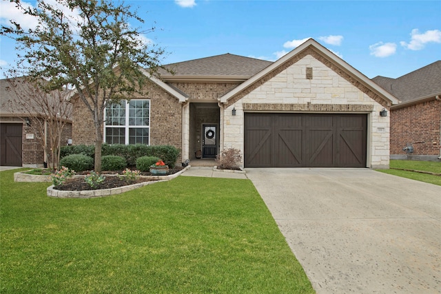 view of front of house with a garage, driveway, a shingled roof, stone siding, and a front yard