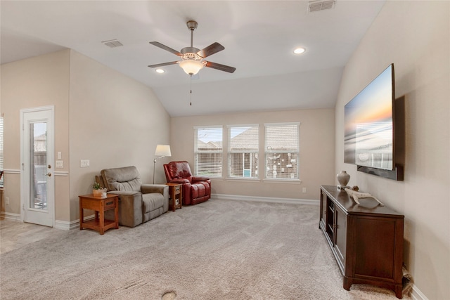 sitting room featuring light carpet, baseboards, visible vents, and vaulted ceiling