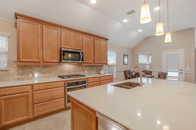 kitchen with visible vents, decorative backsplash, appliances with stainless steel finishes, vaulted ceiling, and a sink