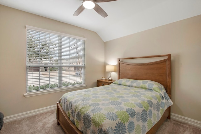 bedroom with carpet, multiple windows, and vaulted ceiling