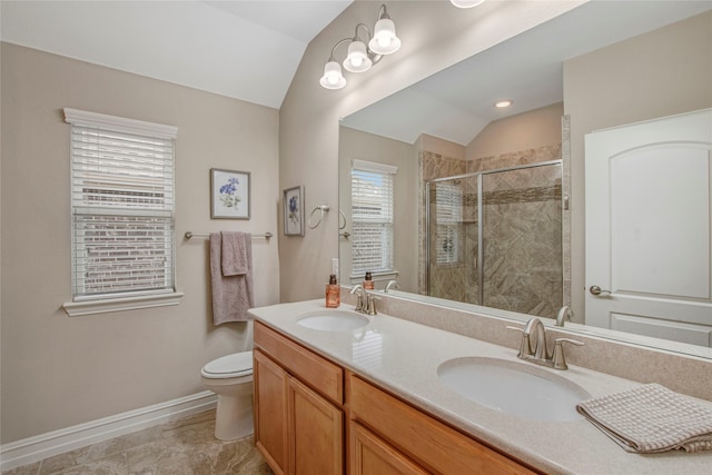 bathroom with lofted ceiling, a sink, and a shower stall