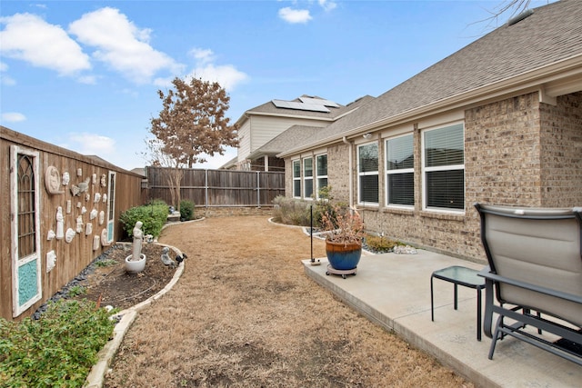 view of yard featuring a patio area and a fenced backyard