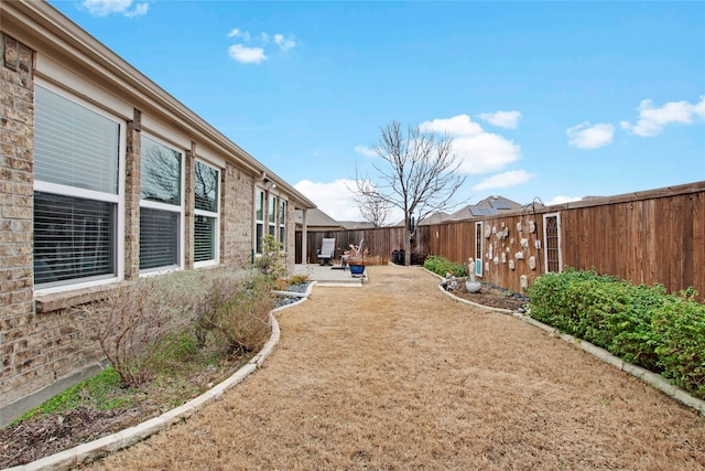 view of yard featuring a patio area and a fenced backyard