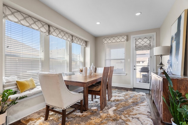 dining room featuring recessed lighting, baseboards, a wealth of natural light, and wood finished floors