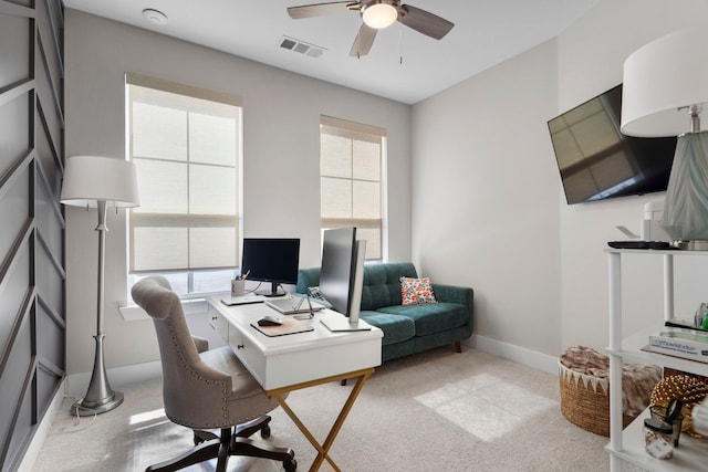 office space featuring a healthy amount of sunlight, carpet floors, baseboards, and visible vents