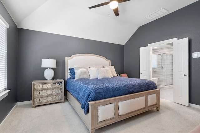 carpeted bedroom with lofted ceiling, connected bathroom, visible vents, and baseboards