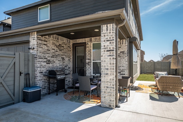 view of patio / terrace featuring a gate, a grill, and fence