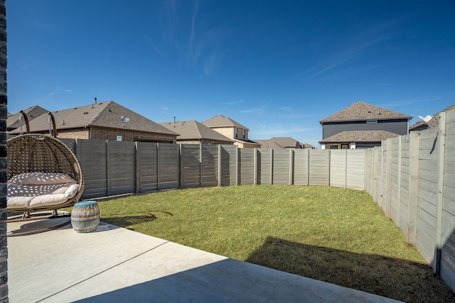 view of yard with a patio area and a fenced backyard