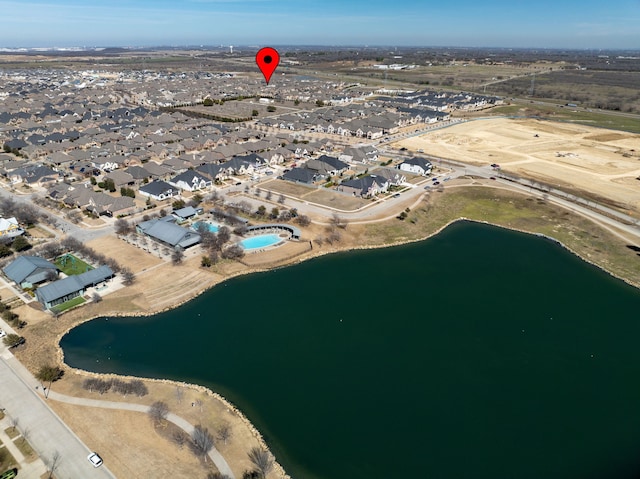 birds eye view of property with a water view and a residential view