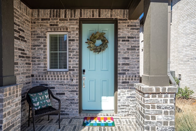 entrance to property with brick siding