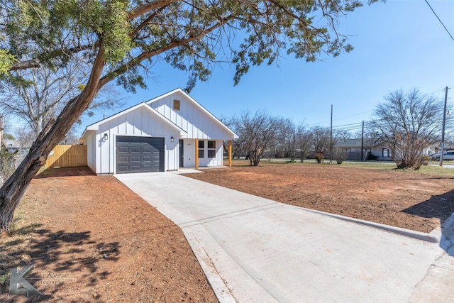 view of front of property with concrete driveway, an attached garage, fence, a porch, and board and batten siding