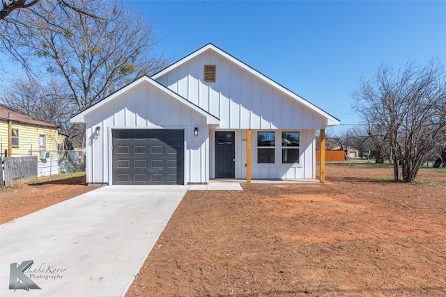 modern inspired farmhouse featuring a garage, concrete driveway, fence, cooling unit, and board and batten siding