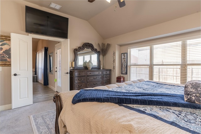 bedroom featuring baseboards, visible vents, light colored carpet, ceiling fan, and vaulted ceiling