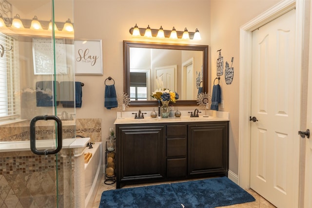 full bathroom featuring tile patterned flooring, a garden tub, a sink, and double vanity