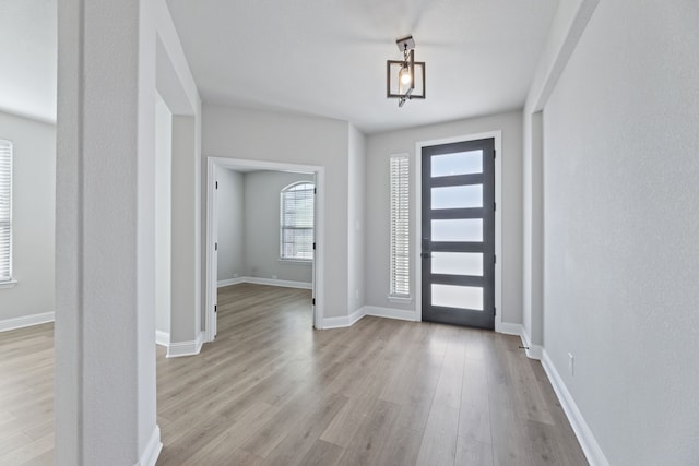 entrance foyer with wood finished floors and baseboards