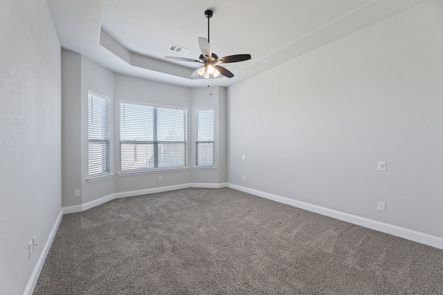 unfurnished room featuring ceiling fan, carpet floors, visible vents, and baseboards