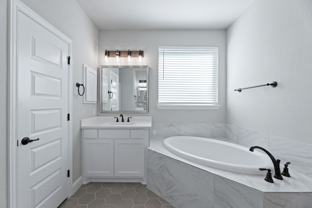 full bathroom with a garden tub, tile patterned flooring, and vanity