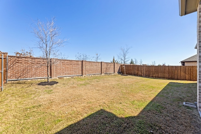 view of yard with a fenced backyard