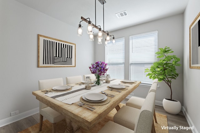 dining space featuring visible vents, wood finished floors, and a wealth of natural light