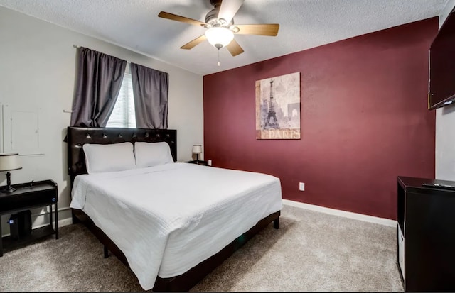 bedroom featuring a textured ceiling, carpet flooring, and baseboards