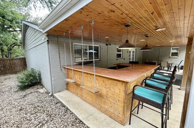 view of patio / terrace featuring fence and outdoor dry bar