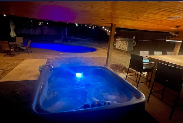 view of swimming pool featuring a fenced in pool, outdoor dining area, a patio area, and a jacuzzi