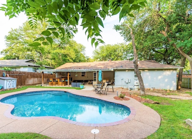 view of swimming pool with outdoor lounge area, a fenced backyard, a patio, and outdoor dry bar