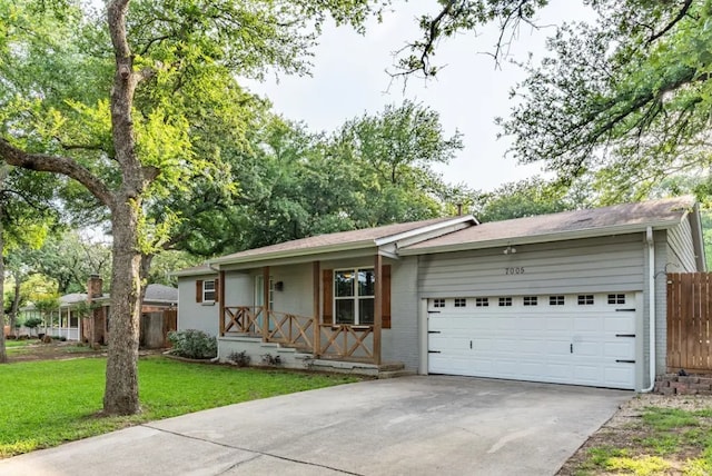 ranch-style home featuring driveway, a garage, fence, a porch, and a front yard