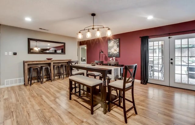 dining room with light wood-type flooring, french doors, visible vents, and recessed lighting