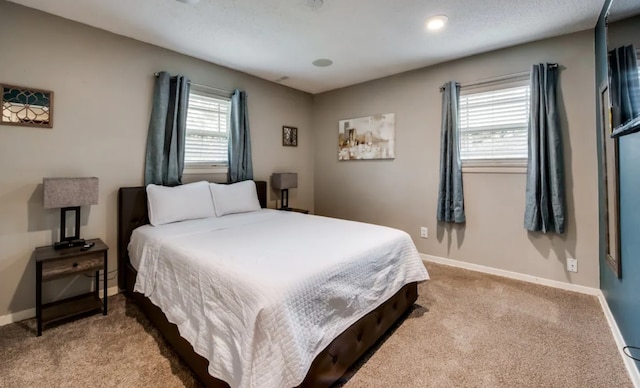 carpeted bedroom featuring baseboards