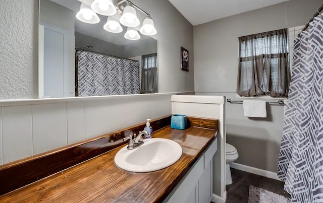 bathroom with vanity, toilet, and a shower with curtain