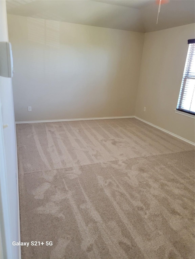 unfurnished room with carpet floors and baseboards