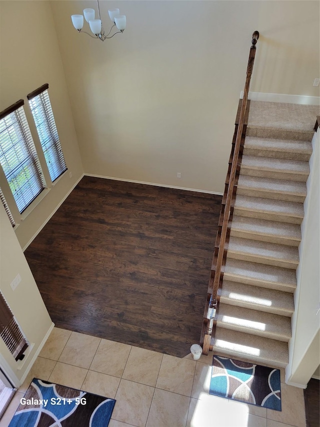 interior space with a notable chandelier, baseboards, and tile patterned floors