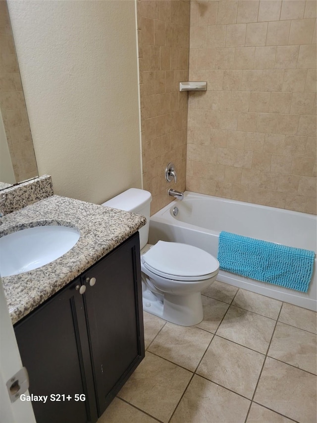 full bathroom with toilet, tile patterned floors, shower / washtub combination, and vanity