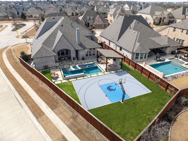 view of swimming pool featuring a fenced backyard, a gazebo, a lawn, a residential view, and a patio area