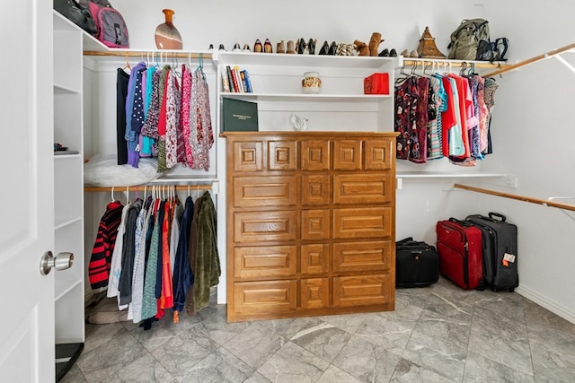 spacious closet with marble finish floor