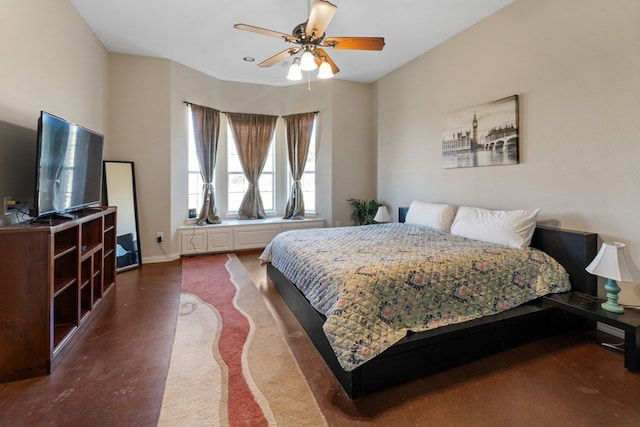 bedroom featuring ceiling fan and baseboards