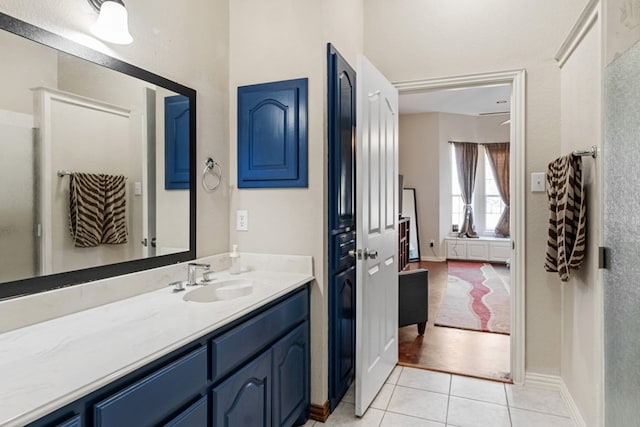 bathroom featuring tile patterned flooring, baseboards, and vanity