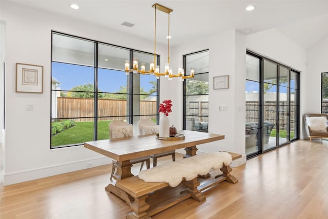 dining space featuring an inviting chandelier, wood finished floors, visible vents, and recessed lighting