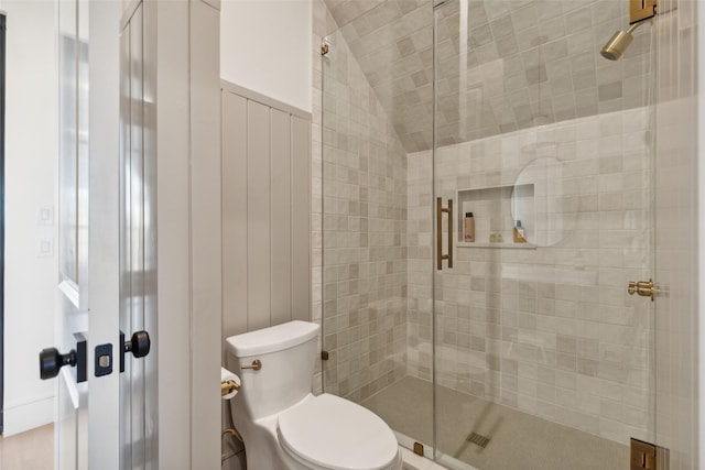 full bathroom with toilet, lofted ceiling, and a stall shower