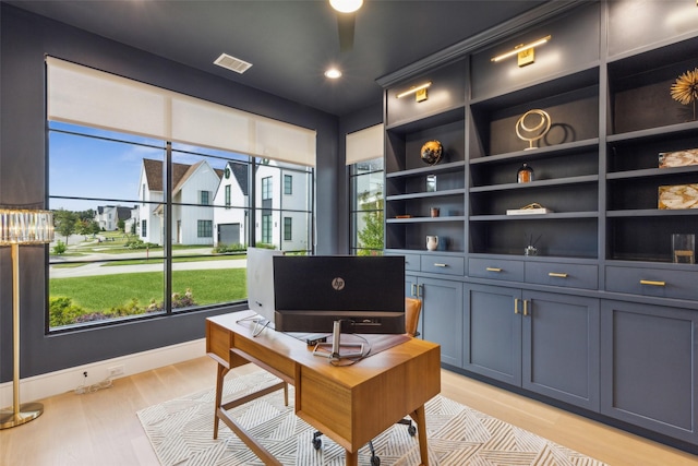 office space featuring light wood finished floors, visible vents, a wealth of natural light, and recessed lighting