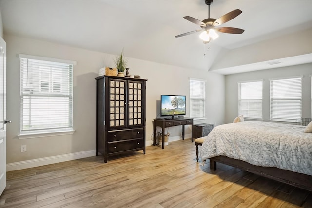 bedroom with vaulted ceiling, visible vents, light wood-type flooring, and baseboards