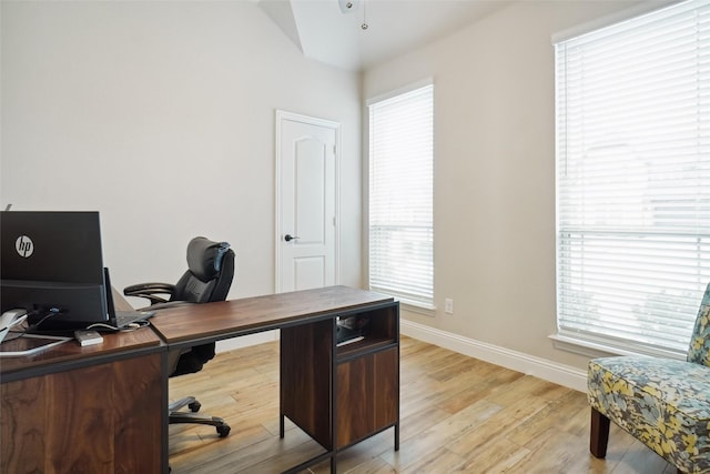 office space featuring light wood-type flooring and baseboards