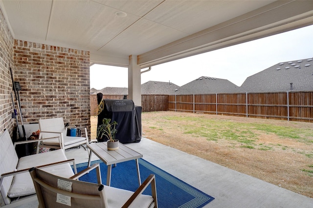 view of patio featuring an outdoor living space, a fenced backyard, and grilling area