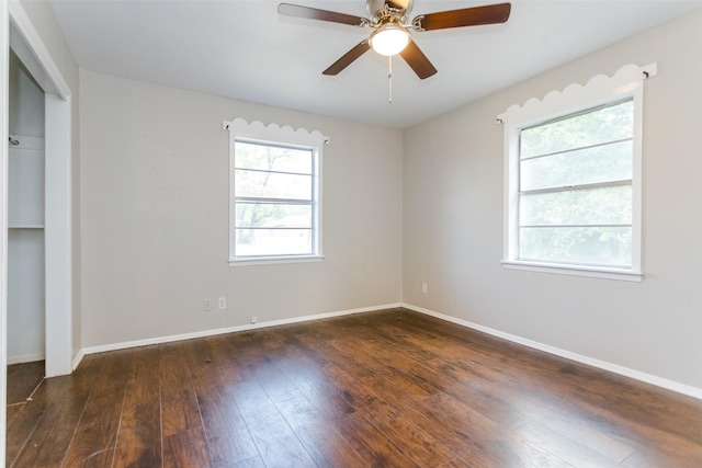 unfurnished room featuring a ceiling fan, baseboards, and hardwood / wood-style flooring