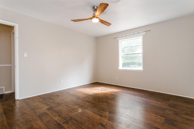 unfurnished room featuring dark wood-style floors, visible vents, and a ceiling fan