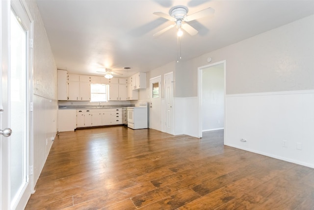 kitchen featuring white electric stove, wood finished floors, white cabinetry, a ceiling fan, and light countertops