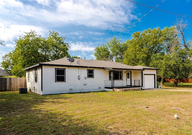 rear view of house featuring a garage, central AC unit, crawl space, and a lawn